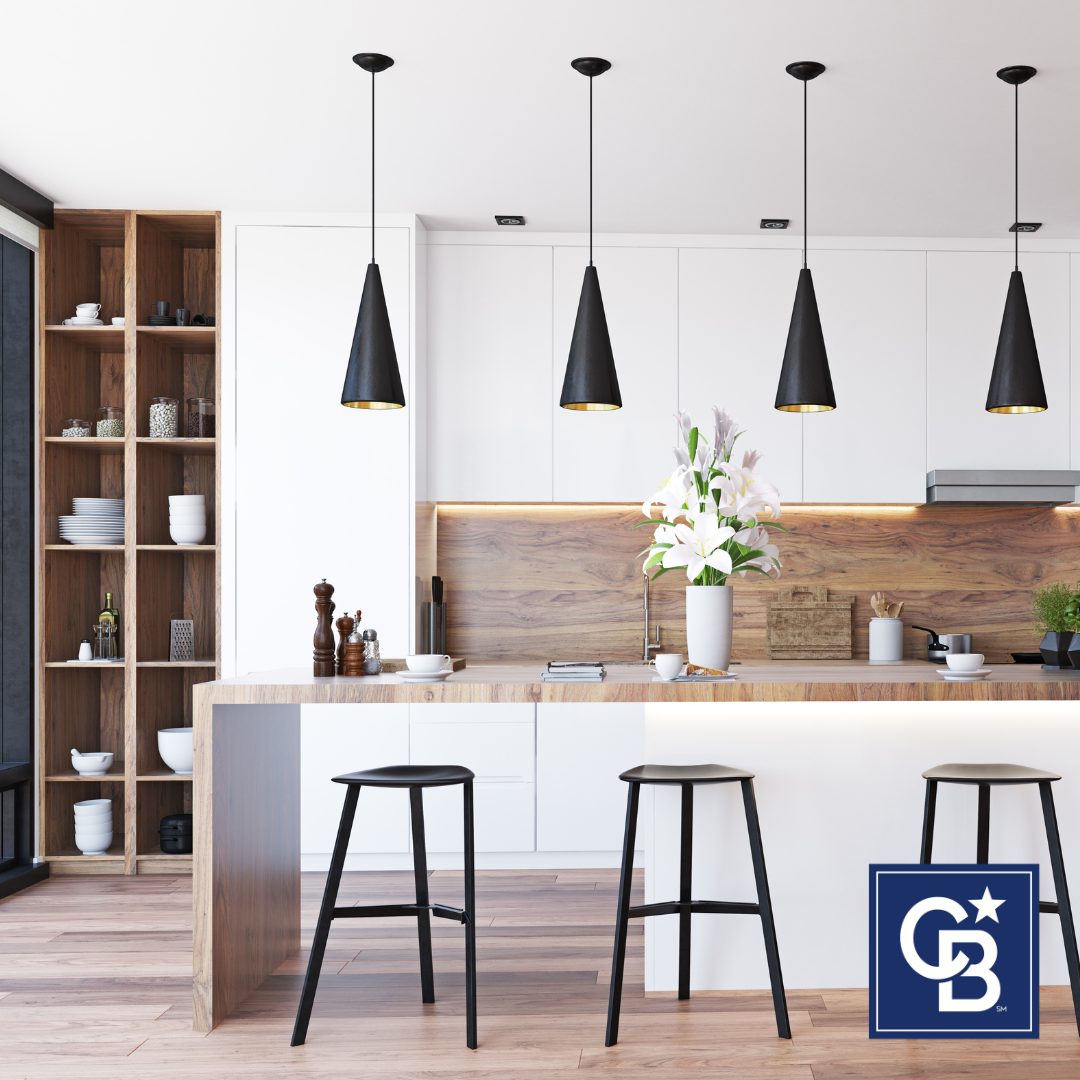 A beautifully staged kitchen featuring modern appliances, fresh flowers, and neutral decor to create an inviting and spacious feel for potential buyers.