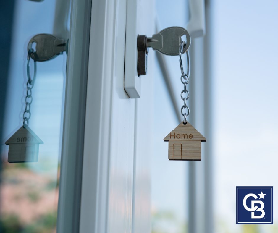 A close-up photo of a key in the lock of a front door, symbolizing a new home purchase or sale.