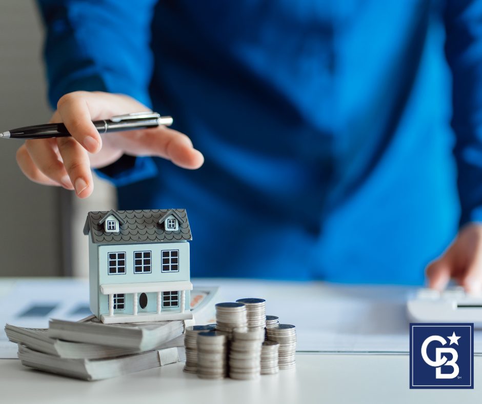 A man carefully reviewing home pricing documents with a real estate agent, ensuring he is avoiding home selling mistakes.