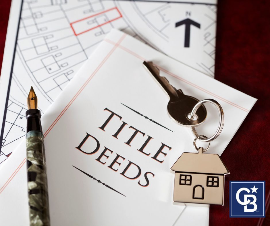 A set of house keys, a pen, and official title deed documents neatly placed on a table, symbolizing a successful property closing.