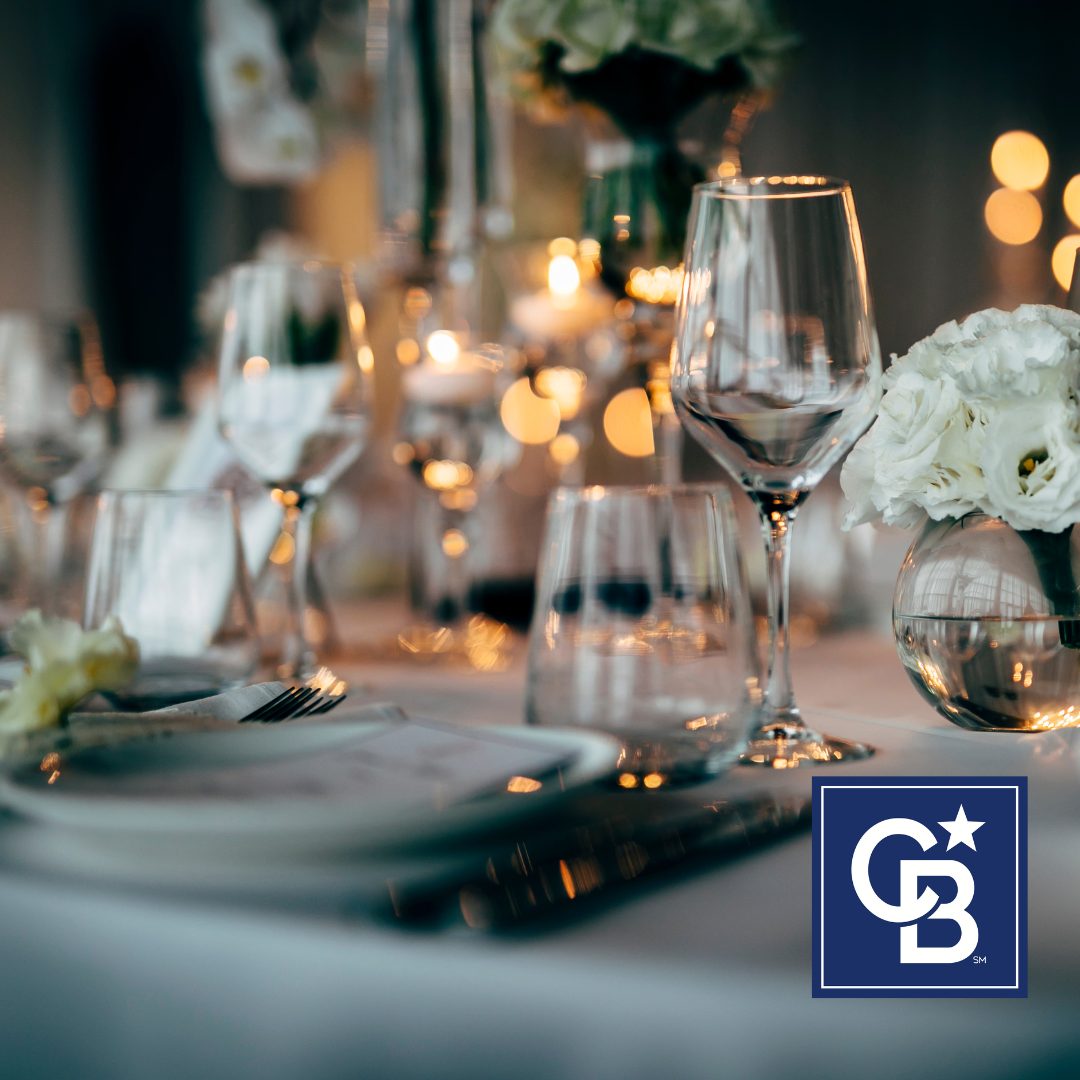 Beautiful evening outdoor dining table with glowing string lights, fresh flowers, and layered place settings, showcasing elegant summer table settings.