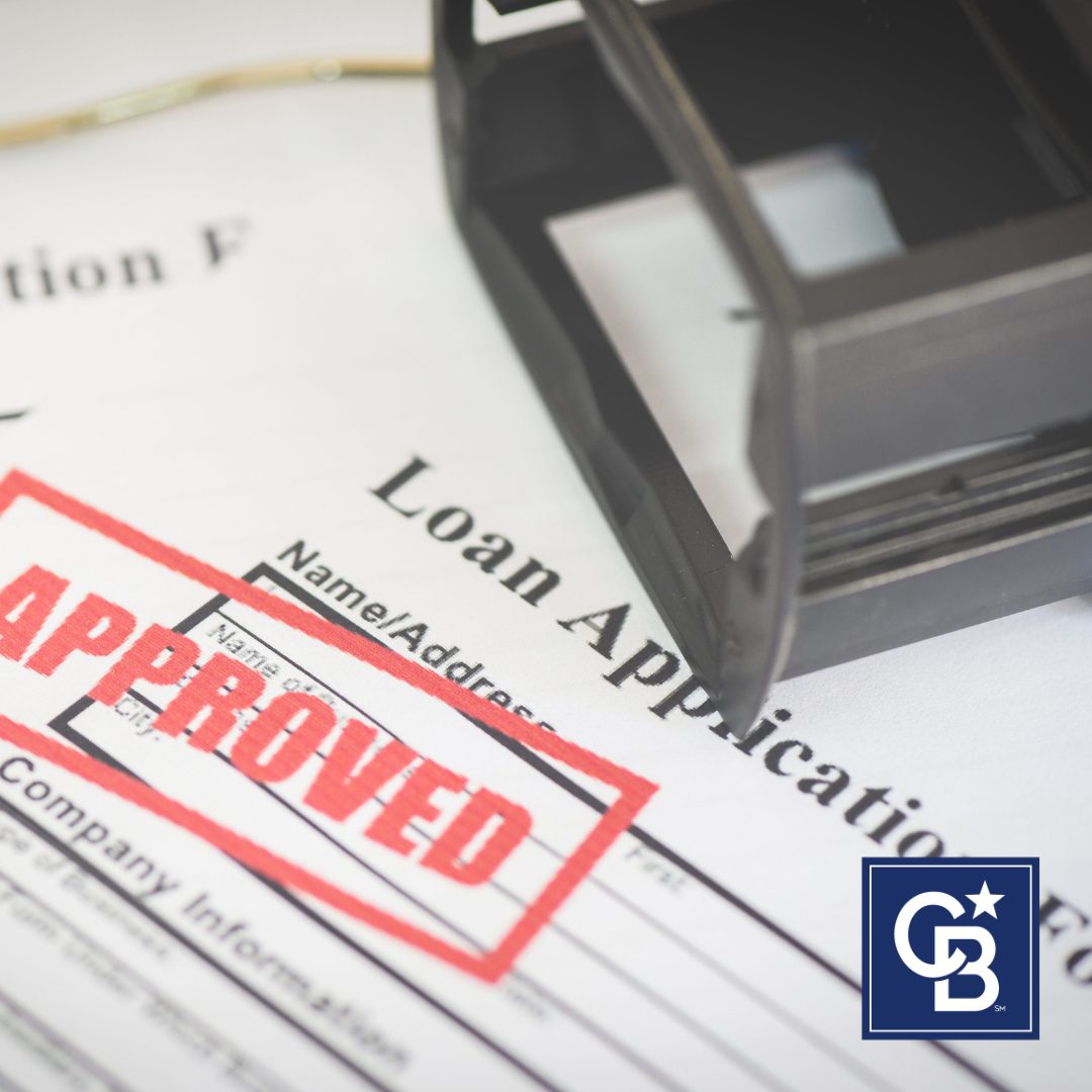 Approved loan application on a table symbolizing increased mortgage credit availability.
