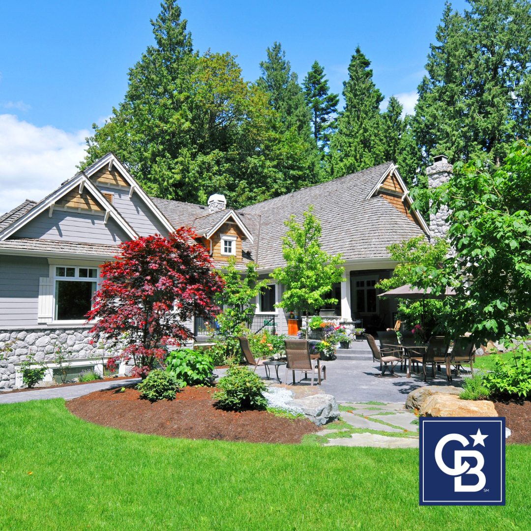 A well-maintained Colorado home with vibrant landscaping and lush greenery, showing how to keep your yard pretty in the heat of summer.